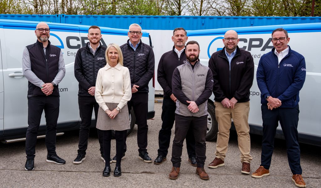CPA sales team standing in front of two vans